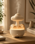 Hushona Mist Rainfall Aromatherapy Diffuser glowing on a wooden desk with warm ambient light and indoor plants